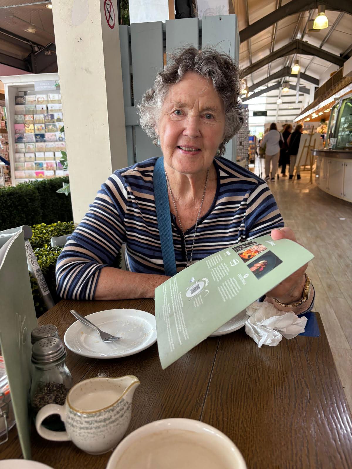 Elderly person enjoying coffee at home — dignified, independent life with Aura Life support